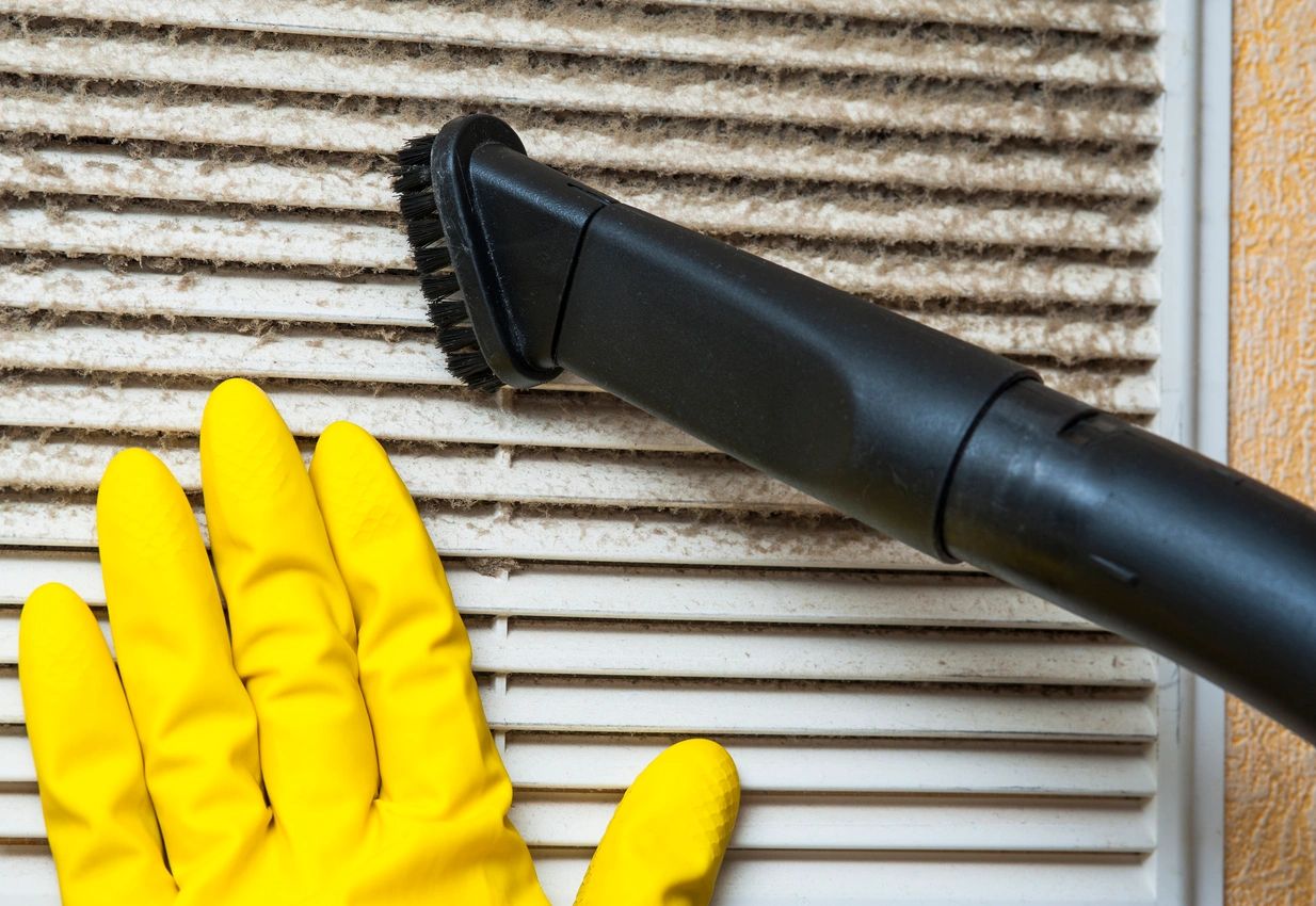 Dirty air duct filled with dust and debris, showing the need for professional duct cleaning to improve indoor air quality in Hampton, VA.